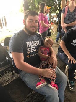 Ted with a baby from Ipetí Guna asleep in his arms on the first trip in 2018