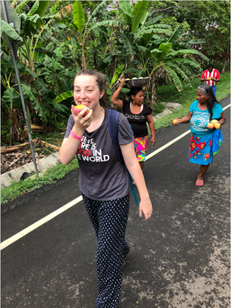 Elizabeth, president, eating a mango while walking the streets of Puerto Lara, Panama